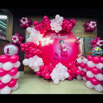 Pink and white balloon decoration with personalized round backdrop