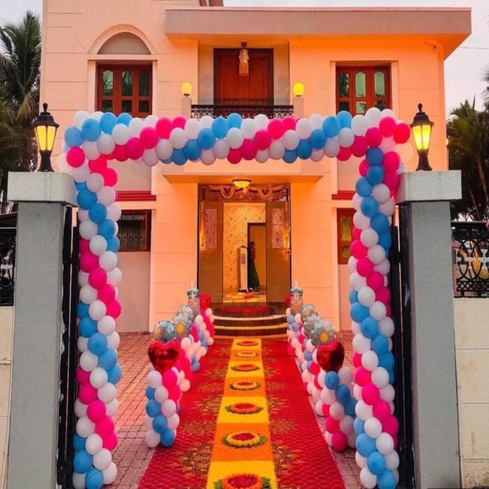 Pink, blue and white balloon arch for housewarming entrance
