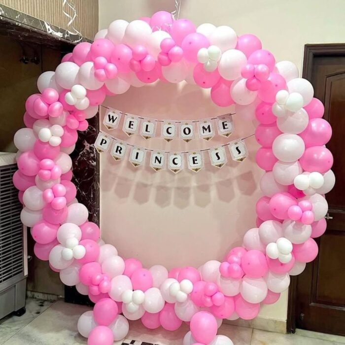 Pink and white balloon arch with “Welcome Princess” banner for baby girl celebration
